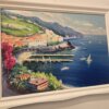 Veduta Panoramica Costiera Amalfitana - Quadro Iannicella Vista angolare del dipinto che mostra la profondità della prospettiva costiera, la vegetazione fiorita in primo piano e la cornice bianca