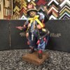 Statuetta Scio'Scio' il venditore di corna portafortuna alta 25cm con giacca blu e amuleti rossi.