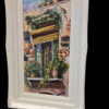 Prospettiva laterale opera O Balcunciell Inquadratura laterale del dipinto 'O Balcunciell che evidenzia la profondità della cornice e i colori vivaci della facciata dipinta.