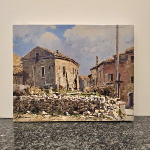 Dipinto olio su tela raffigurante vecchie case di campagna in pietra con un muretto a secco in primo piano e cielo nuvoloso, firmato A. Romano.