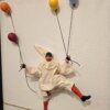 pulcinella-in-terracotta-fatto-a-mano-dettaglio-personaggio Primo piano del dettaglio in terracotta e vestito in tessuto fatto a mano del personaggio di Pulcinella con palloncini